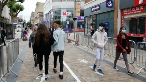 Google Members of the public walk through the city centre which has been marked out with social distancing markings on July 04, 2020 in Wolverhampton, England