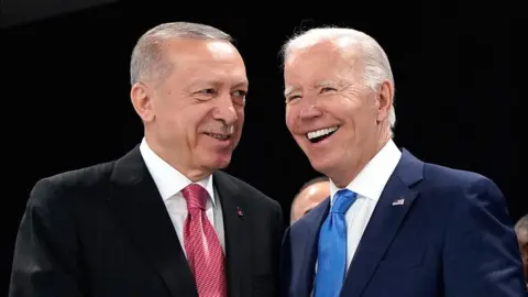 Getty Images Turkish President Recep Tayyip Erdogan (left) shakes hands with US President Joe Biden in 2022