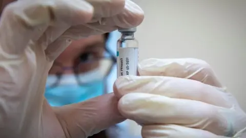 Getty Images Pharmacist holding AstraZeneca vial