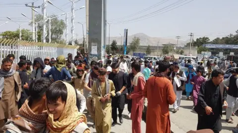 Getty Images Thousands of Afghans rush to the Kabul International Airport as they try to flee the Afghan capital of Kabul