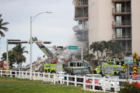 Reuters Emergency crew members search for missing residents in a partially collapsed building in Surfside, near Miami Beach, Florida, U.S., June 24, 2021.
