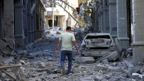 A man walks amidst rubble in the aftermath of Israeli strikes in Nabatieh, Lebanon, June 15, 2026. 