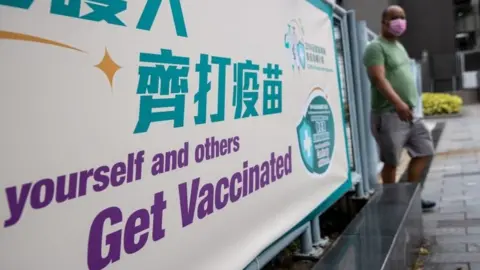 EPA A man walks out of a community vaccination centre for the Sinovac Biotech Ltd. Covid-19 vaccine in Hong Kong