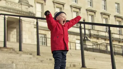 BBC Dáithí MacGabhann on the steps of Stormont after the bill passed