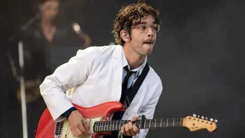 PA Media Matt Healy performs at a festival in Glasgow