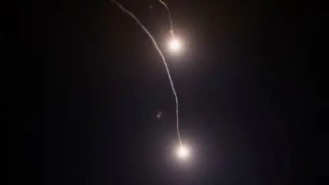 Reuters Traces of the explosions are seen in the sky over Kyiv