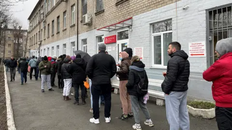 Sarah Rainsford A long queue outside a blood donation centre