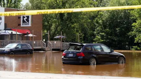 Vehicles partially submerged are seen after the heaviest rain to hit the Atlantic Canadian province of Nova Scotia in more than 50 years triggered floods, in Bedford, Halifax, Nova Scotia, Canada July 23, 2023. REUTERS/John Morris