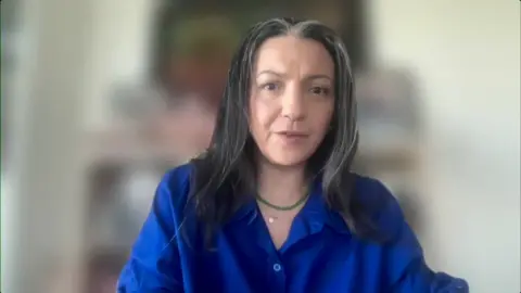 Shaimaa Khalil wearing a blue shirt