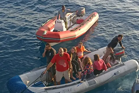 Survivors inform BBC of terrifying escapes Handout Survivors on two dinghies. There are eight people on one vessel - it is not clear how many are survivors and how many are rescuers. There is one man in the other dinghy.