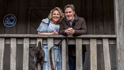 BBC / Salamanda Media / Nick Maxted Rob Brydon and Dolly Partons niece Heidi Parton. They are standing on the porch of a remake of Dolly's childhood home