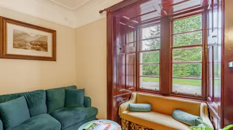 Fine & Country Scotland A panelled wood window with chairs next to it