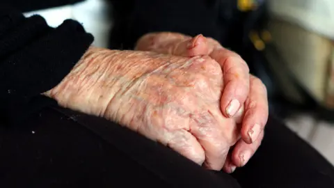 Generic image of the hands of an elderly woman at home