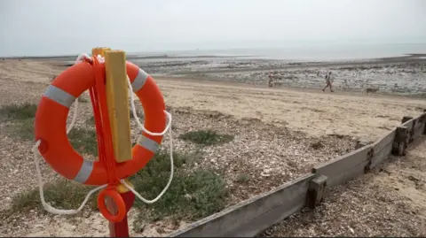 A lifebuoy on a pole at West Mersea beach