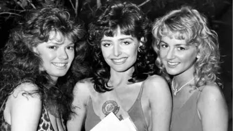 Mirrorpix/Getty Images Rachel Meritt with two other woman with long hair in a black and white picture.