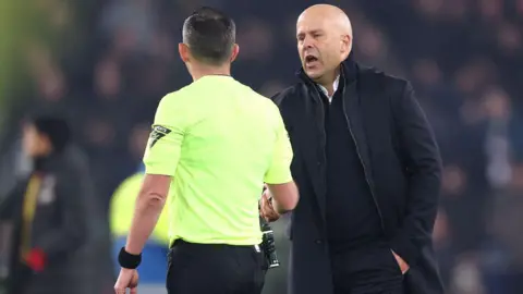 Arne Slot shakes hands with referee Michael Oliver