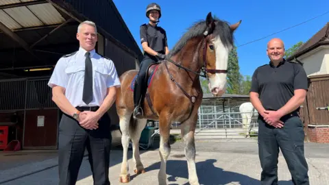 Assistant Chief Constable Richard Robertshaw stands next to PC Cassie Barratt, riding PH Lawson, with Inspector Tim Coussens 