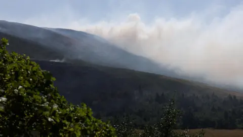 Reuters Smoke from a moorland blaze rises near the Dovestone Reservoir.