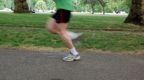 Unidentified man running through Green Park, London