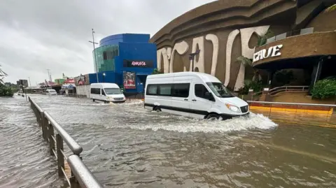 EPA Cars cross a street flooded by Hurricane Helene in the beach resort of Cancun, Quintana Roo, Mexico, 25 September 2024. 