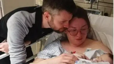 Sarah Conroy Sarah Conroy holding son Kit