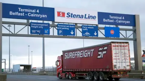 PA Media A lorry arriving at Larne port. There is a sign for Terminal 4 Belfast-Cainryan and Stena Line.