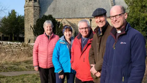 Martin Booth Trustees outside the church in Hudswell (l-r) - Annie Sumner, Heather Swettenham Martin Booth, Ian Whinray and the Revered Martin Fletcher