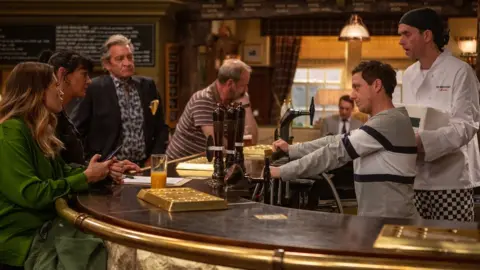 Amy Brammall/ITV A still from a scene in the pub from Emmerdale