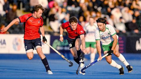 Ireland’s Daragh Walsh takes on two Great Britain players in the Pro League game in London