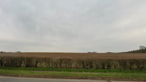 Agricultural land beyond the edge of a road