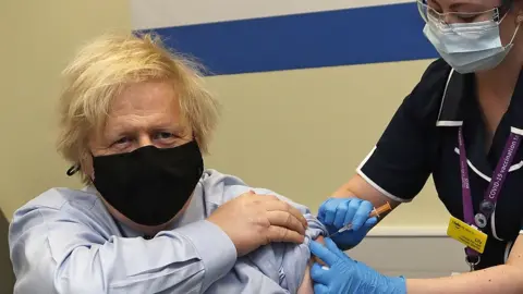 Getty Images MARCH 19: Britain's Prime Minister Boris Johnson receives the first dose of the AstraZeneca vaccine administered by nurse and Clinical Pod Lead, Lily Harrington at St.Thomas' Hospital on March 19, 2021 in London, England