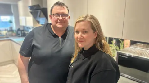 BBC John and Becky Ball are standing in their kitchen