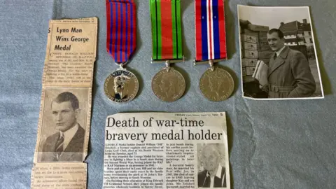 Martin Giles/BBC Two newspaper clippings, a black and white photograph and medals of Donald William Setchell. 