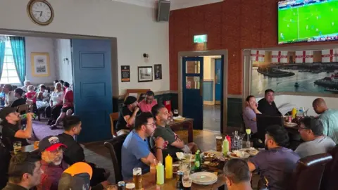 Bik Singh / The Maggies Customers watching the England match at The Maggies pub.