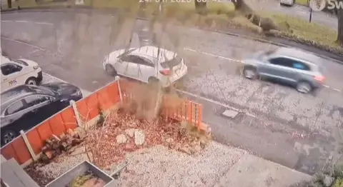 Tree falls over road as car being driven on it