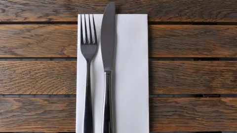 Knife and fork on napkin