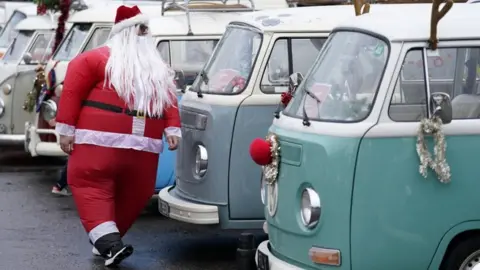 Andrew Matthews/PA Wire Santa with campervans