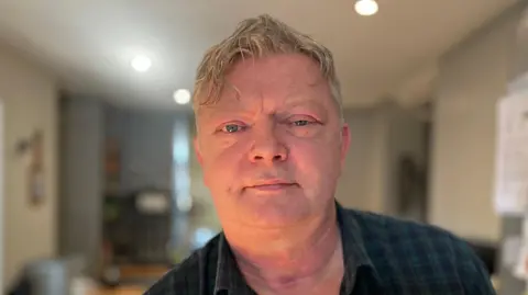 Jason Bayliss, aged 55, in his kitchen