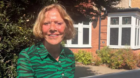 Andrea Charman standing in front of her house in Branksome