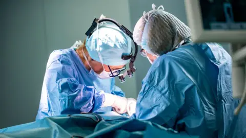 Getty Images Two surgeons working