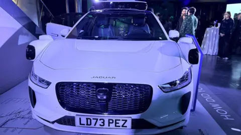 Zoe Kleinman A white Jaguar car 