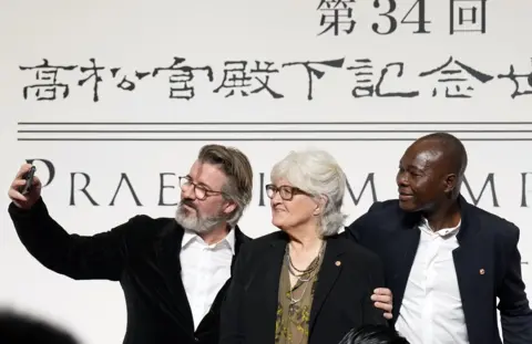 FRANCK ROBICHON/EPA Icelandic-Danish artist Olafur Eliasson, US painter Vija Celmins and Burkinabe architect Diebedo Francis Kere take a selfie before a photocall for the 34th Praemium Imperiale in Tokyo, Japan, 17 October 2023. The Praemium Imperiale is a global arts prize awarded annually by the Japan Art Association. Five laureates are nominated in the fields of Painting, Sculpture, Architecture, Music and Theatre/Film. For its 34th edition, the Praemium Imperiale awards have been given to US painter Vija Celmins, Icelandic-Danish artist Olafur Eliasson, Burkinabe architect Diebedo Francis Kere, US musician Wynton Marsalis and US theater director Robert Wilson.