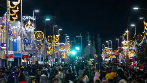Belgrave Road in Leicester at Diwali with Diwali lights lit-up and hundreds of people celebrating