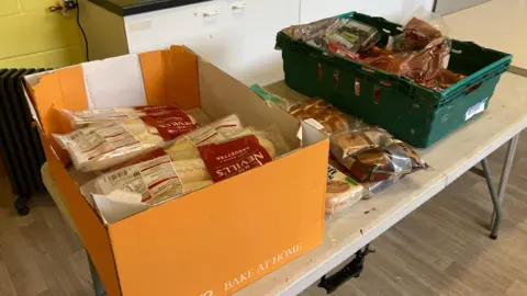 A photo of a table containing boxes of food at the Phoenix Centre in Maston in Gloucester