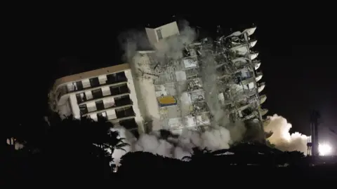 View of the partially collapsed Champlain Towers South residential building as it is demolished, in Surfside, Florida, 4 July 2021