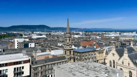 An aerial view across Inverness showing the city centre towards the Longman, the Kessock Bridge and the Black Isle beyond.