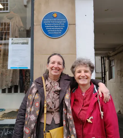 York Civic Trust Rabbi Dr Elisheva Salamo (left) and Dr Louise Hampson (right) stand in front of the blue plaque