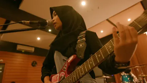 Firdda Marsya Kurnia, vocalist and guitarist for Voice of Baceprot, inside a recording studio