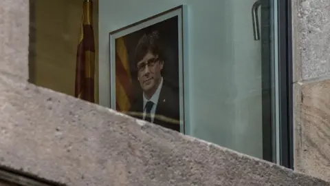 Getty Images portrait of Carles Puigdemont seen through a window of the Palau de la Generalitat, 30 October 2017