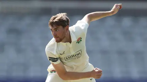 George Balderson bowling for Lancashire